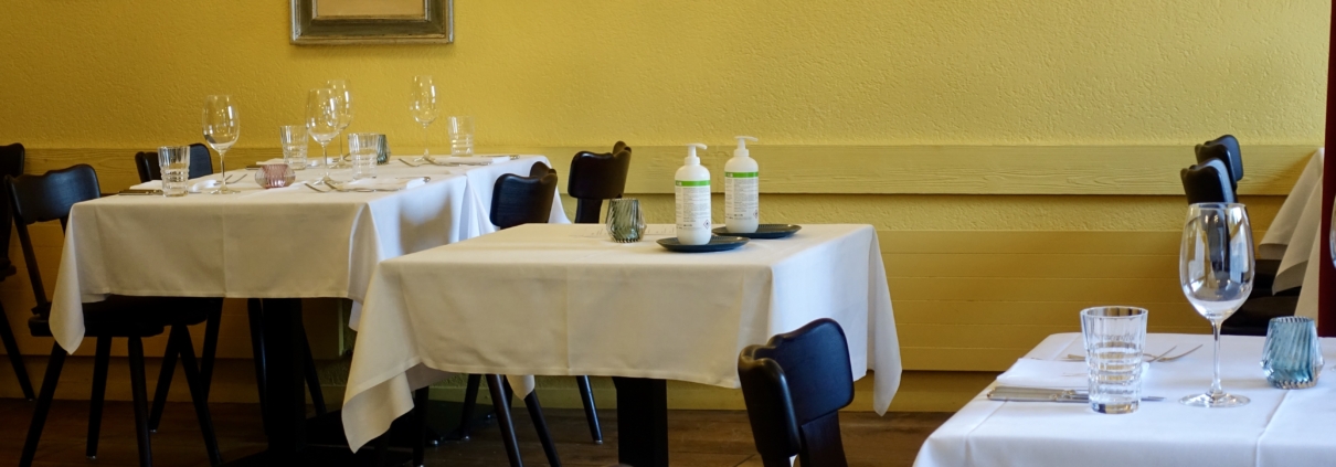 Restaurant interior: empty table & disinfectant